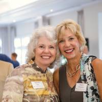 Marcia Haas smiling with guest at Naples 2019